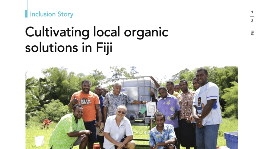 Group of farmers and partners gathered around an OrganicPlus filling station in Fiji.