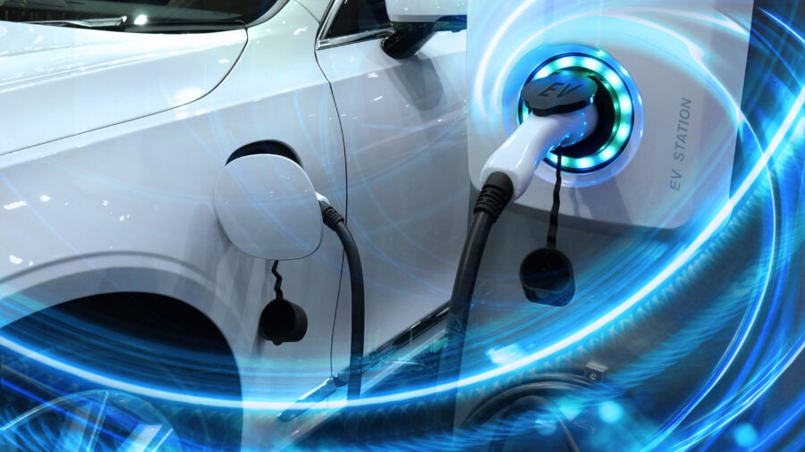 Electric vehicle plugged into an EV charging station with blue energy light effects.