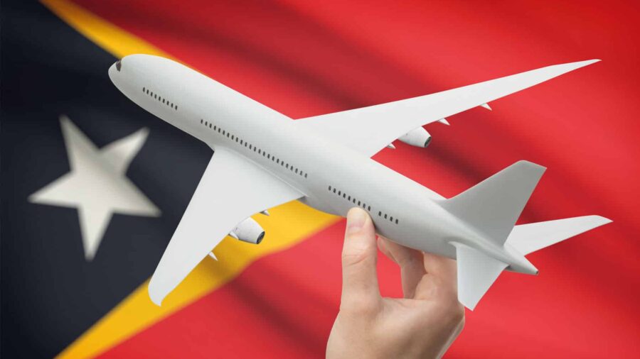 toy passenger aircraft is help over on the Timorese flag, representing Qantas' new commercial flights to Dili, Timor-Leste.