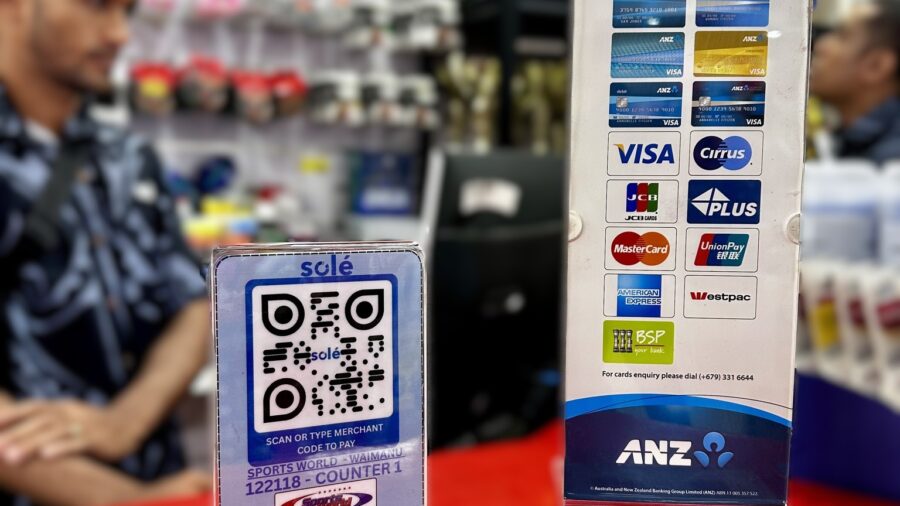 Solé QR payment code and card acceptance sign displayed on a retail counter.
