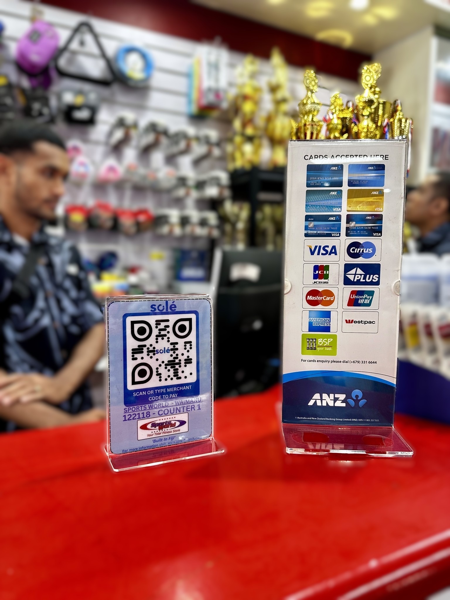 Solé QR payment code and card acceptance sign displayed on a retail counter.