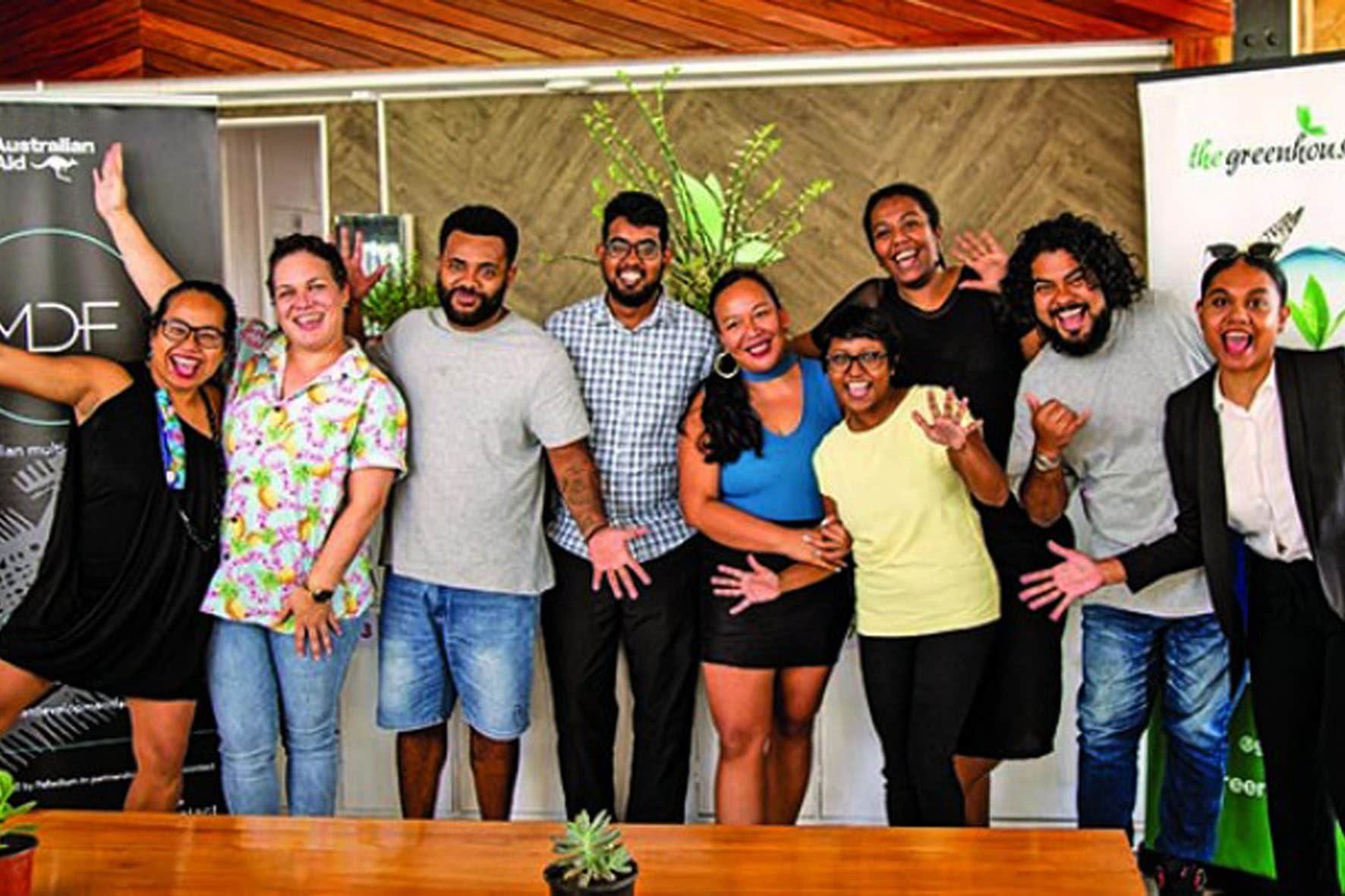 Group of people smiling and waving at the Greenhouse Coworking launch in Fiji.