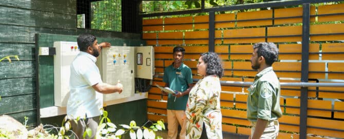 Group reviewing an outdoor electrical control panel at Thema Collection.