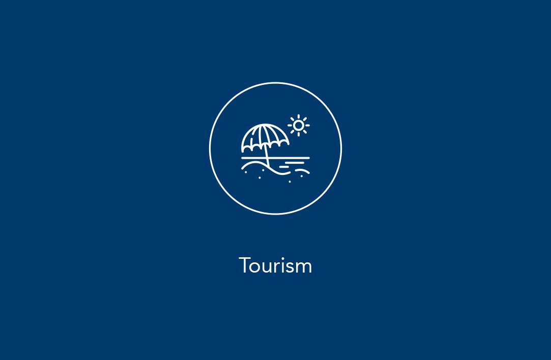 White line icon of a beach umbrella, sun and waves above the text “Tourism” on a blue background.
