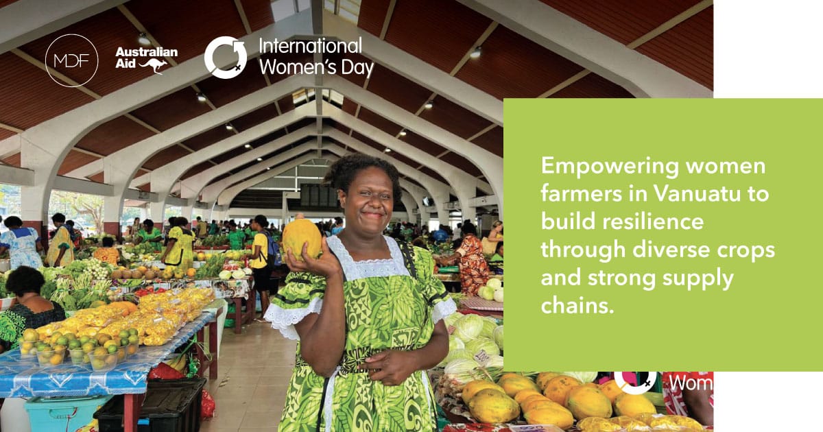 A Women Farmers happily shows off her locally grown produce in the local markets in Vanuatu